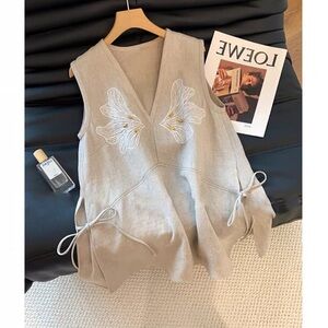 Elegant Beige Sleeveless Top with Embroidered Floral Design